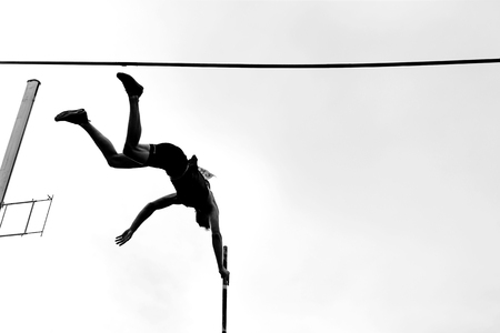 pole vault athlete pole vaulter jump in athletics black and white imageの写真素材
