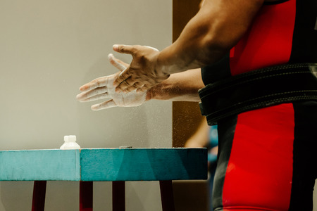 athlete powerlifter hands with chalk magnesia before attempting deadliftの写真素材
