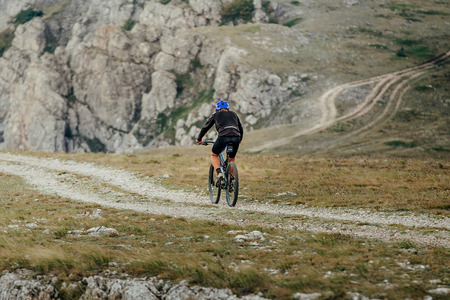 mountain biking on mountain trail healthy lifestyle