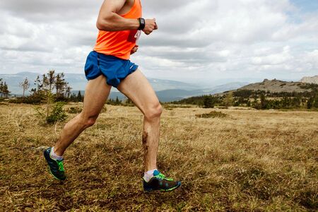 male athlete runner running dirty mountain trail marathon race