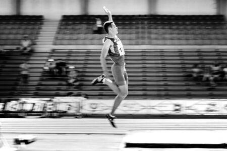Chelyabinsk, Russia - July 12, 2019: male athlete long jump motion blur during Championship in...