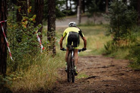 athlete cyclist riding downhill  to mountainbike in forest trailの写真素材