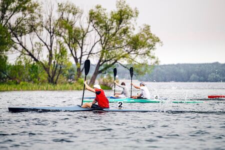 group athletes kayakers competition race in rowing on kayak