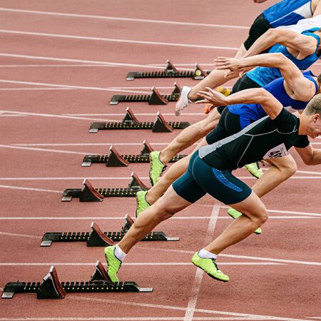 start sprint race men runners athletes in athletics competition