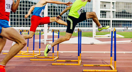 race 400 meters hurdles men athletes running in athleticsの写真素材