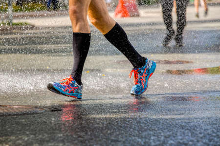 Ekaterinburg, Russia - August 7, 2016: legs man runner in running shoes ASICS in Europe-Asia Marathonのeditorial素材