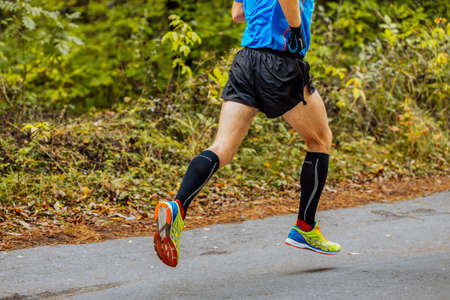 Chelyabinsk, Russia - September 11, 2016: legs man athlete runner in running shoes Asics Gel DS Racer 10 in City marathonのeditorial素材