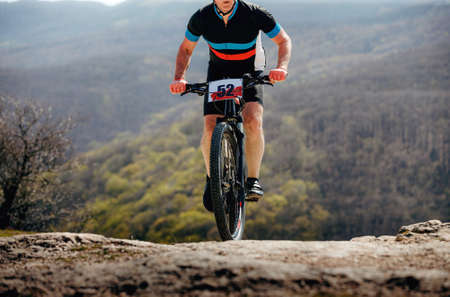 male athlete on mountainbike riding mountain trail on raceの写真素材
