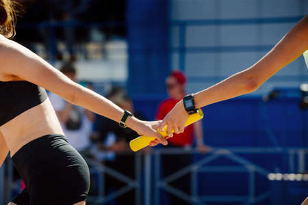young women relay race for track and field competitionの写真素材