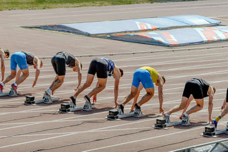 group runners athletes in starting blocks at athletics competitionの写真素材