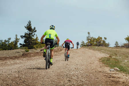 group cyclist biking mountain bike on uphillの写真素材