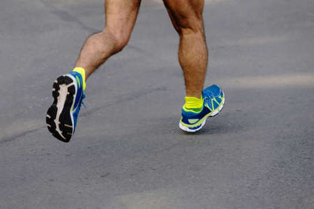 legs male runner athlete run asphalt roadの写真素材