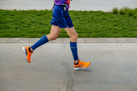 Kazan, Russia - May 17, 2022: legs runner athlete in compression socks during Kazan Marathon