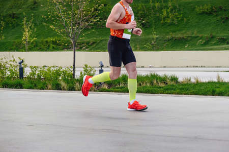male athlete in compression socks run parkの写真素材