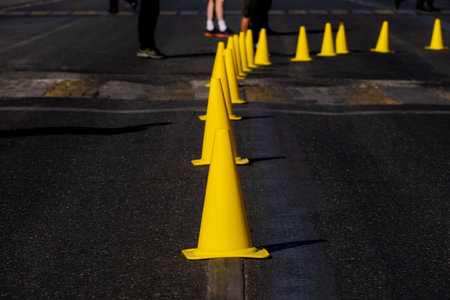 yellow traffic cones on dark asphalt indicating turn