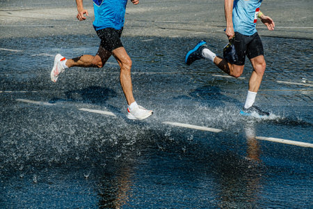 two runners running water station in hot weatherの写真素材