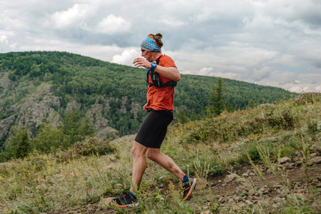 Bannoe, Russia - July 31, 2022: athlete runner run mountain descent in MMK Wild Trailのeditorial素材