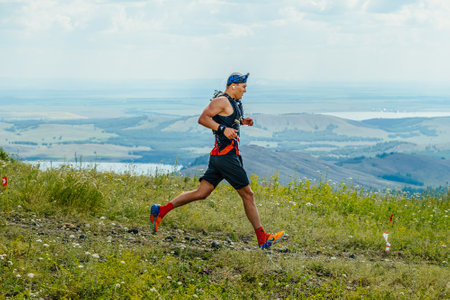 Bannoe, Russia - July 31, 2022: male athlete runner run mountain descent in MMK Wild Trailのeditorial素材