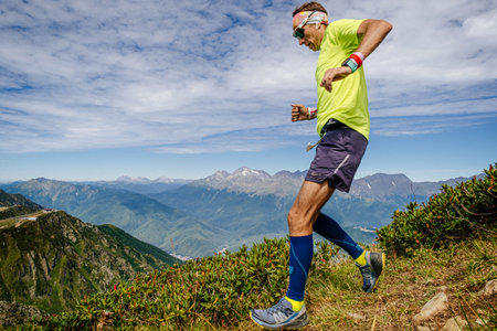 Rosa Khutor, Russia - September 10, 2022: male athlete running down steep mountainside in Rosa Wild Trailのeditorial素材