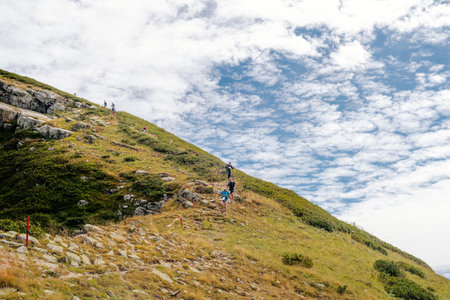 Rosa Khutor, Russia - September 10, 2022: group athletes running down mountainside in Rosa Wild Trailのeditorial素材