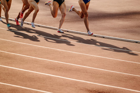 legs group female athletes run middle distance race at stadium, spikes shoes for running Nike, sports photoのeditorial素材