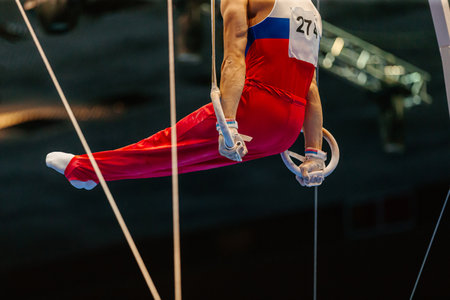 male gymnast exercise l-sit position on ring frame competition artistic gymnastics, summer sports gamesの写真素材