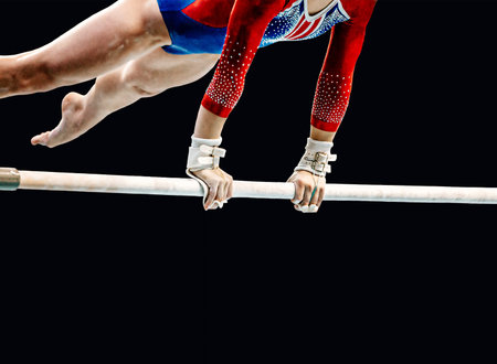 close-up female gymnast exercise on uneven bars in artistic gymnastics, black background, sports summer gamesの写真素材