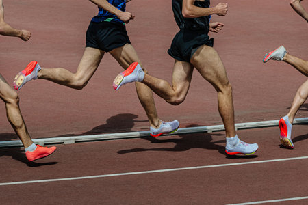 group male runner middle-distance running at track stadium in summer athletics championshipsの写真素材