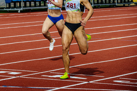 female runner athlete running finish line sprint race track stadium, summer athletics championshipsの写真素材