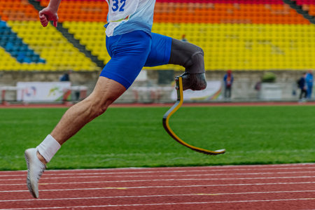 male runner para athlete on limb deficiency running track stadium, summer para athletics championshipsの写真素材