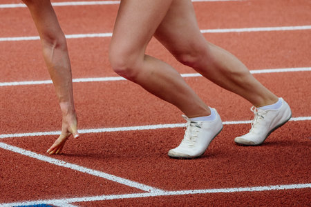 female athlete runner starting position run sprint race red track stadium, summer athletics championshipsの写真素材