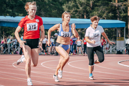 Chelyabinsk, Russia - August 28, 2015: woman runners athletes 60 years old running race in masters athletics summer competitionのeditorial素材