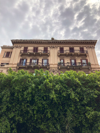 old house in Palermo in background of sky and green treesの写真素材