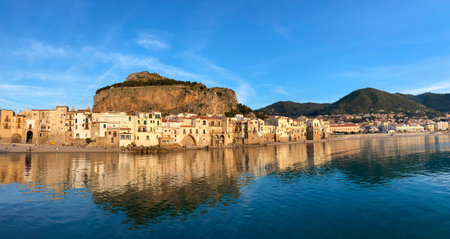 panorama old town of Cefalu with beach on background of mountainの写真素材