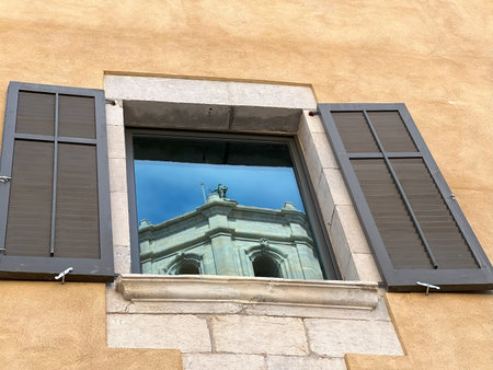 reflection of Girona Cathedral in window of apartment buildingの写真素材