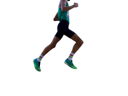 side view male runner running marathon, figure in shadowsの写真素材