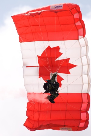 June 26, 2011. St. Thomas Ontario Canada. Members of the Canadian Forces parachute team the "Skyhawks" make their way to the ground during an exhibition at the Great Lakes International Air Show in St. Thomas Ontario.のeditorial素材
