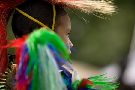 London, Canada - September 17, 2011: A First Nations Canadian wearing traditional clothing participates in a Pow Wow dance during the annual Native Harvest Festival and Pow Wow at the Attawandaron Village located in the Museum of Ontario Archaeology in Loのeditorial素材