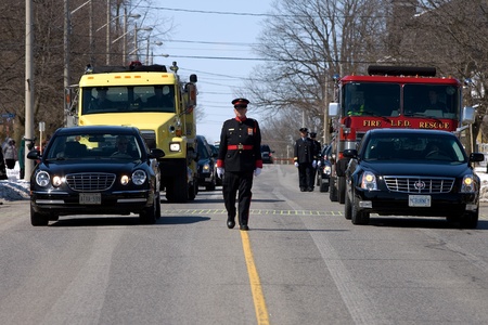 March 24, 2011. Listowel, Ontario. Thousands of firefighters from Ontario, Quebec and the United States converged on Listowel to honour volunteer firefighters Ken Rae 56 and Raymond Walter 30. The two died while battling a fire on March 17, 2011. のeditorial素材