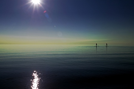 Bayfield Ontario, Canada - July 20, 2010. Two individuals paddle out onto Lake Huron just before...