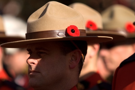 London Ontario, Canada - November 11, 2011. RCMP Officers with Poppies in their signature Stetson headgear during Remembrance Day ceremonies at the Cenotaph in Victoria Park in London Ontario Canada. のeditorial素材