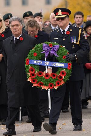London Ontario, Canada - November 11, 2011. Joe Fontana, Mayor of London, left and Brad Duncan, Chief of Police for City of London prepare to lay a wreath during Remembrance Day ceremonies at the Cenotaph in Victoria Park in London Ontario Canada. のeditorial素材