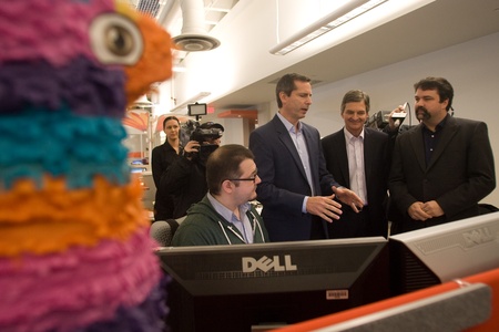 London Ontario, Canada - November 28, 2011. Dalton McGuinty Premier of Ontario speaks with Mukney Tipping, a designer with Digital Extremes (seated) Chris Bentley, MPP for London West, second from right and James Schmalz, president and founder or Digital のeditorial素材