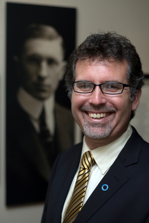 London Ontario, Canada - August 5, 2011. Grant Maltman, Curator at Banting House. He is photographed in front of a portrait of Dr. Frederick Banting's located inside Banting House in London Ontario Canada. It was inside this house that Dr. Frederick Bantiのeditorial素材