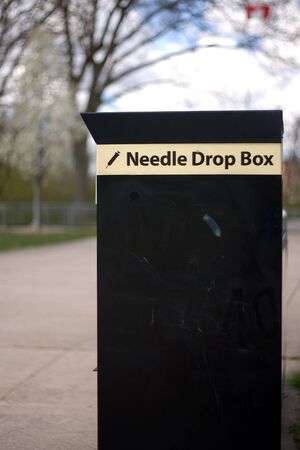 London Ontario, Canada - April 12, 2012. A needle drop box located near a public park in London Ontario Canada. The drop box is designed for I.V. drug users to provided them with a place to dispose of used needles. のeditorial素材
