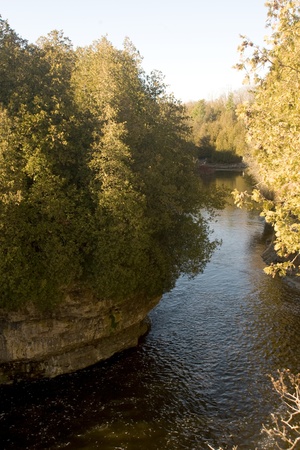 Elora Ontario, Canada - November 14, 2009. Located on the banks of the Irvine and Grand Rivers, the town is best known for its Limestone cliffs and gorge that plummets 70 feet into the Grand River below. The town attracts over 250,000 people each year. Poのeditorial素材