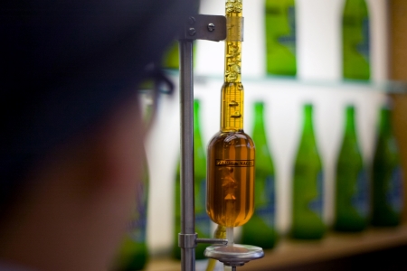Toronto Ontario, Canada - June 5, 2012. Trish Yee, quality assurance technican tests for carbonation and head space gases in a sample of beer. Located in a former Canadian Pacific Rail steam locomotive roundhouse, Steam Whistle brewery produces an averageのeditorial素材