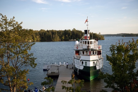 Muskoka Ontario, Canada - September 12, 2012. The Wenonah II of the Muskoka Boat Lines docked at a resort on Lake Rosseau in the Muskoka region of Ontario Canada. Located within two hours north of Toronto, the region is a popular summer haven for many Ontのeditorial素材