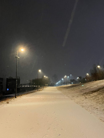 Snowy road in the city at night, closeup of photoの写真素材