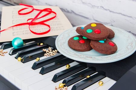 Christmas cookies and music sheet on piano.の写真素材